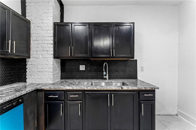 kitchen with dishwasher, backsplash, marble finish floor, light stone countertops, and a sink