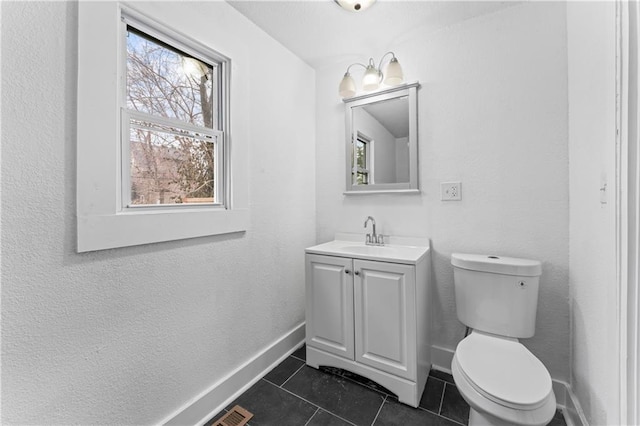 half bath featuring plenty of natural light, tile patterned flooring, and toilet