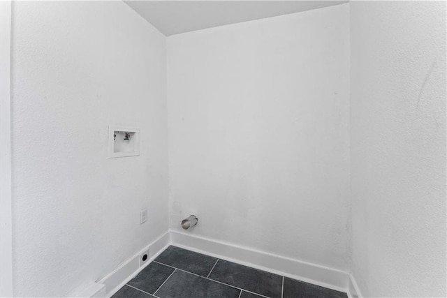 washroom featuring baseboards, laundry area, dark tile patterned floors, and washer hookup