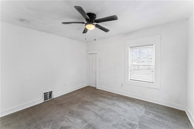 spare room featuring a ceiling fan, carpet, visible vents, and baseboards