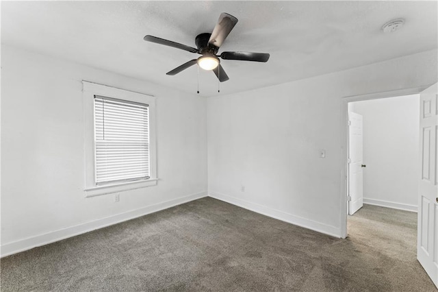 unfurnished room with carpet, baseboards, and ceiling fan