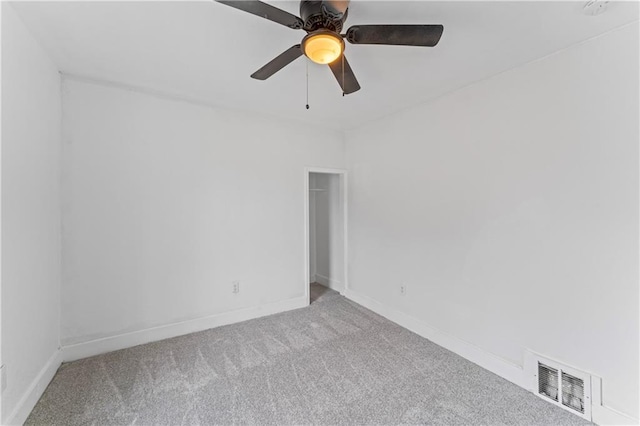 empty room featuring carpet, visible vents, ceiling fan, and baseboards