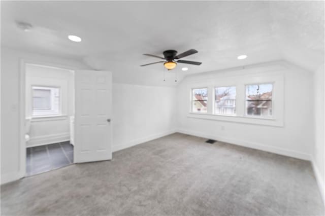 bonus room featuring vaulted ceiling, carpet flooring, visible vents, and baseboards