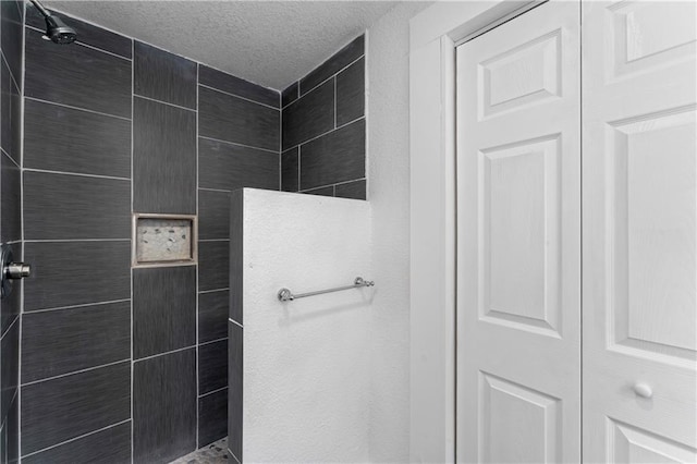 bathroom with a walk in shower and a textured ceiling