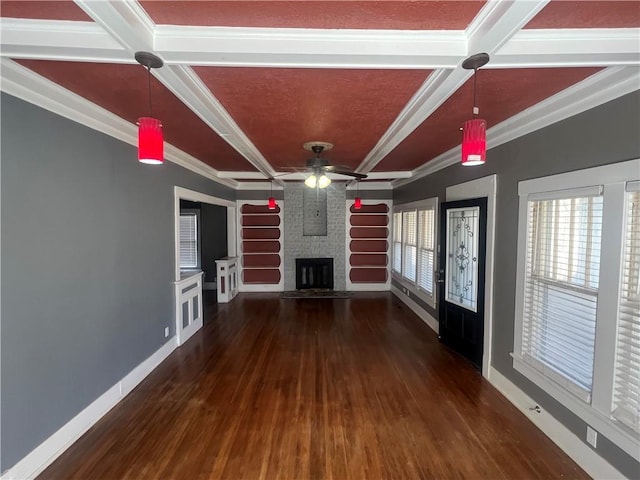 unfurnished living room featuring wood finished floors, a fireplace, coffered ceiling, and baseboards