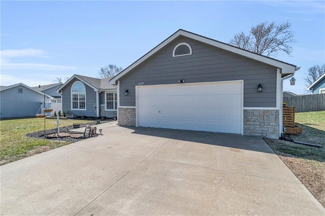 ranch-style house with an attached garage, a front lawn, fence, stone siding, and driveway