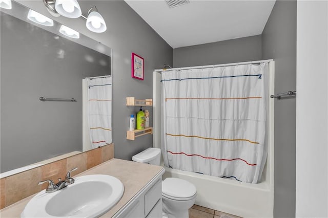 full bathroom with vanity, visible vents, shower / tub combo, tile patterned floors, and toilet