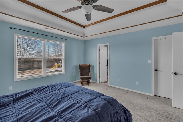 bedroom featuring baseboards, a raised ceiling, ceiling fan, and carpet flooring