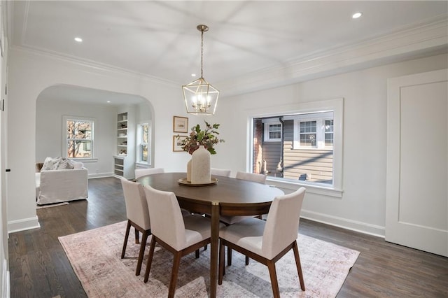 dining area featuring baseboards, arched walkways, a notable chandelier, and dark wood-style flooring