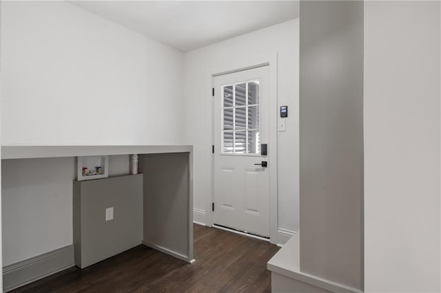 laundry room with dark wood finished floors, laundry area, hookup for a washing machine, and baseboards