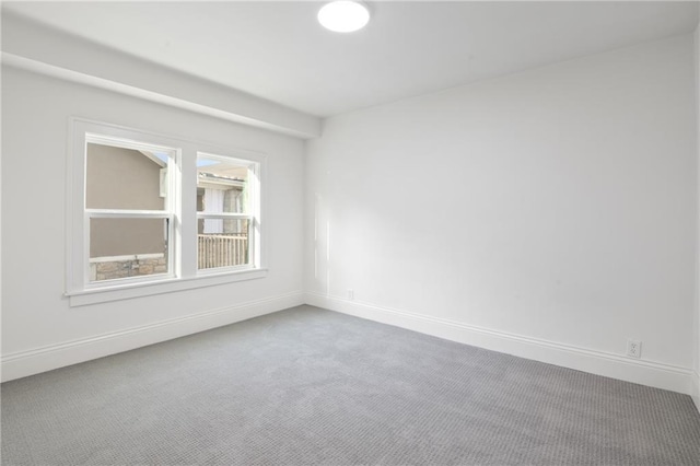 empty room with baseboards and carpet floors