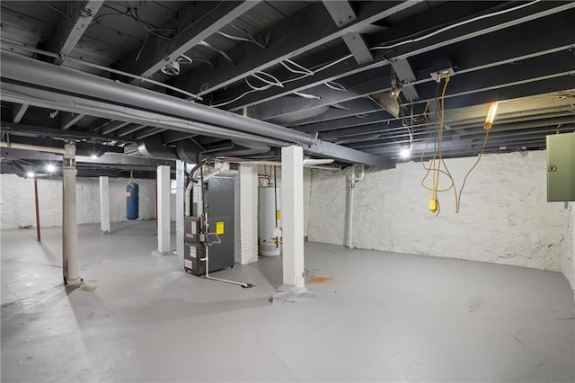 unfinished below grade area with electric panel, heating unit, and water heater