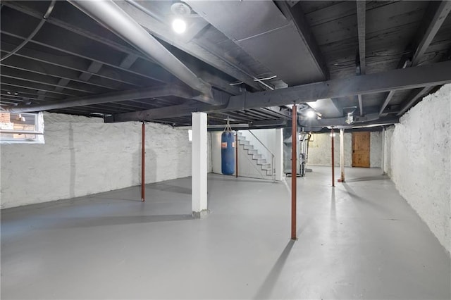 basement with water heater and stairway