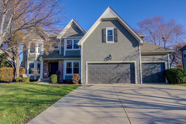 traditional home with stucco siding, brick siding, concrete driveway, and a front lawn