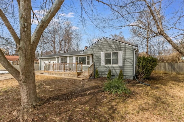 view of front facade featuring fence and a wooden deck