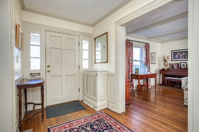 entrance foyer with ornamental molding and wood finished floors