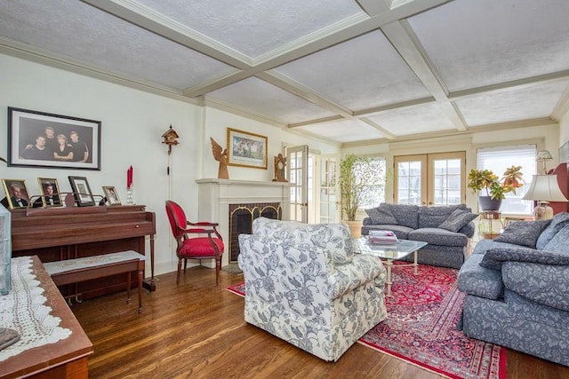 living area with coffered ceiling, a fireplace, and dark wood-style flooring