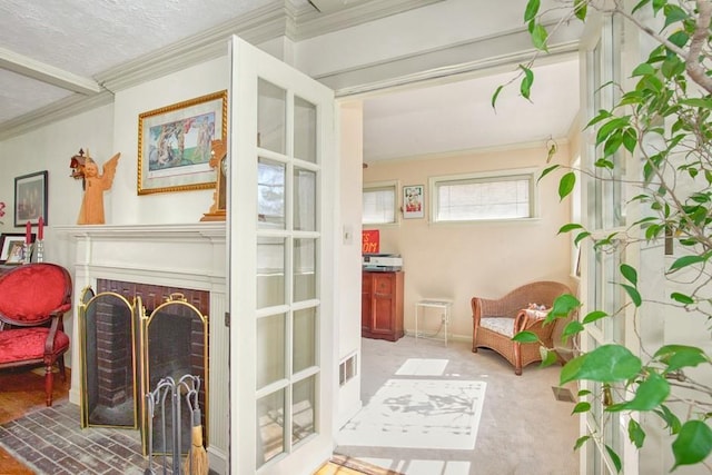 sitting room featuring visible vents, a fireplace, and ornamental molding