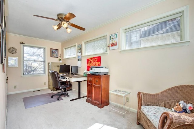 carpeted home office featuring baseboards, crown molding, and ceiling fan