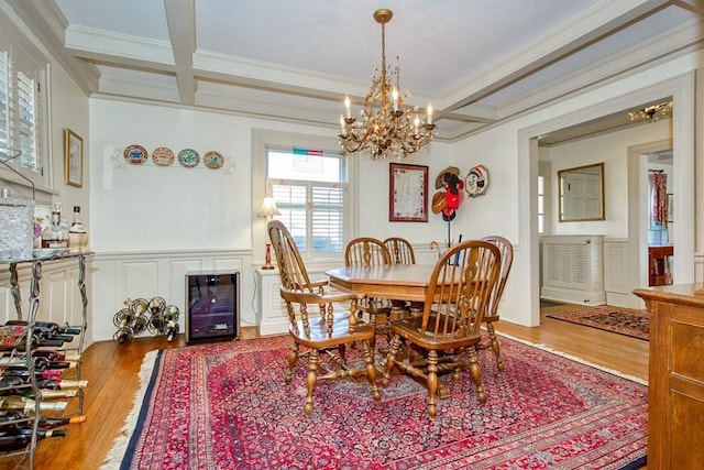 dining area with beam ceiling, a notable chandelier, and coffered ceiling