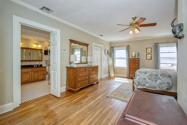 bedroom with crown molding, baseboards, visible vents, and light wood finished floors