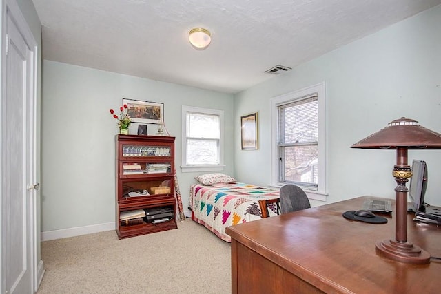 carpeted bedroom with visible vents and baseboards