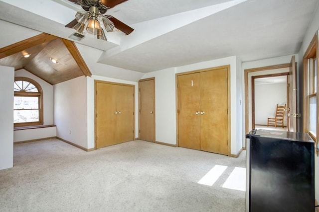 bonus room with ceiling fan, baseboards, and lofted ceiling