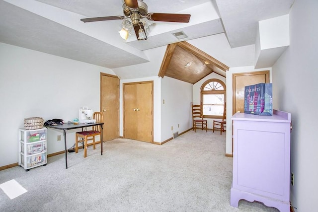 interior space with carpet, baseboards, visible vents, a ceiling fan, and lofted ceiling