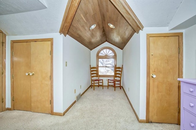 additional living space with vaulted ceiling, baseboards, visible vents, and carpet floors