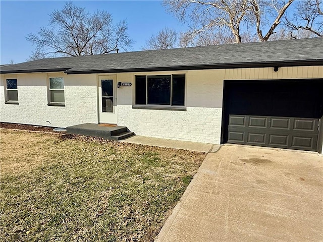 view of front of home with a shingled roof, concrete driveway, a front yard, stucco siding, and an attached garage