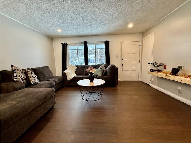 living room featuring dark wood finished floors, baseboards, and a textured ceiling