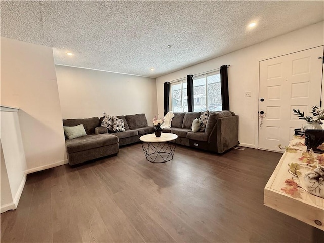 living area featuring dark wood finished floors, recessed lighting, a textured ceiling, and baseboards