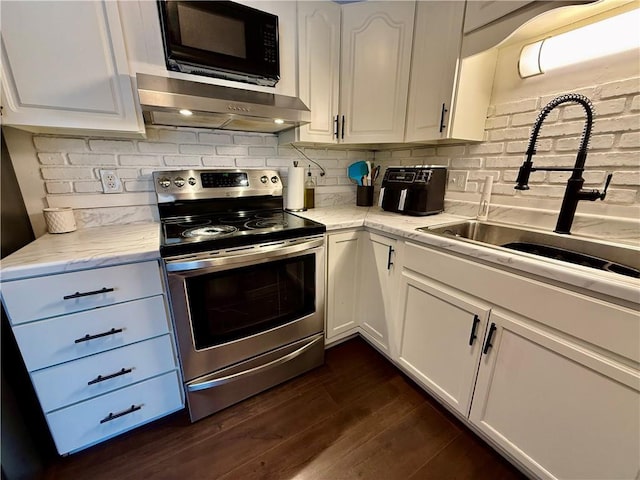 kitchen with a sink, stainless steel range with electric stovetop, white cabinets, under cabinet range hood, and black microwave