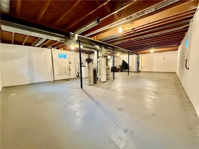 unfinished basement featuring water heater