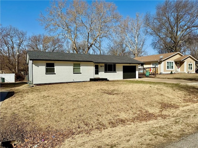 view of front of home featuring an attached garage, driveway, and fence