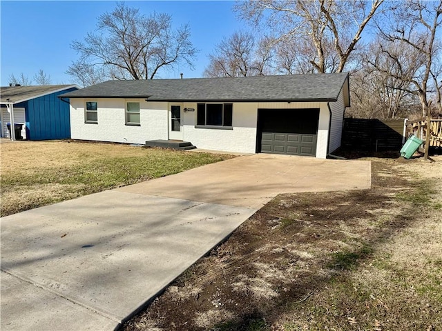 ranch-style home featuring brick siding, a garage, driveway, and roof with shingles