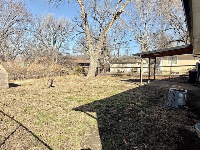 view of yard with a patio, central AC unit, and fence