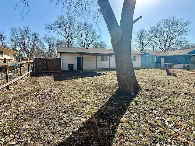 back of house with fence