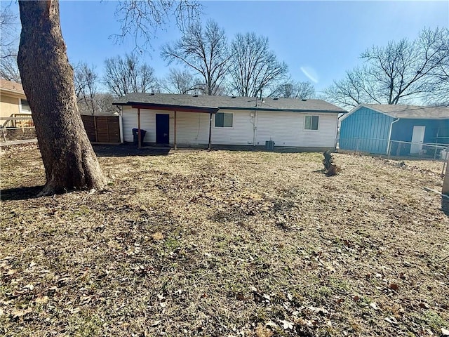 rear view of house with fence