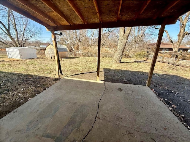 view of patio featuring a fenced backyard, a storage shed, and an outdoor structure