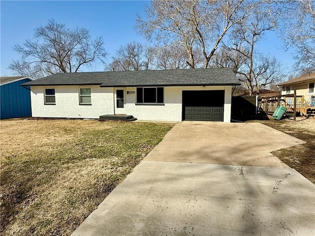 ranch-style house with driveway, a shingled roof, a front yard, an attached garage, and brick siding