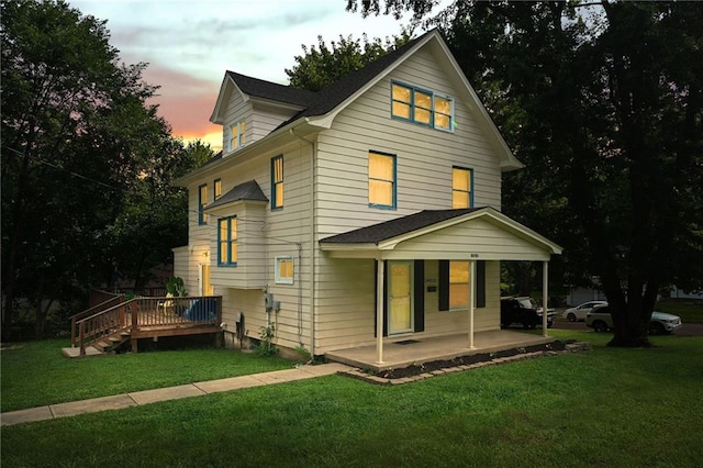 view of front of property featuring covered porch and a front yard