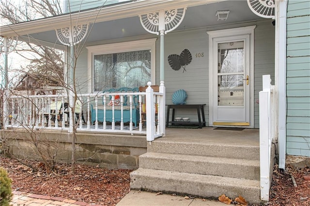 view of exterior entry with a porch