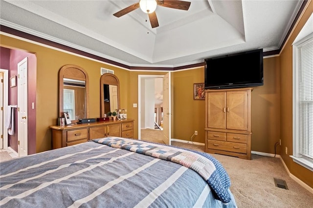 carpeted bedroom featuring ceiling fan, baseboards, visible vents, and a raised ceiling