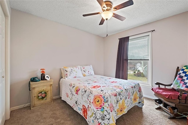 carpeted bedroom with a ceiling fan, a textured ceiling, and baseboards