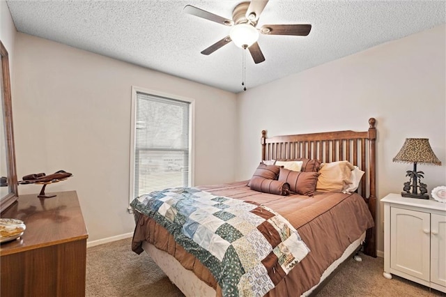 bedroom featuring light carpet, ceiling fan, baseboards, and a textured ceiling