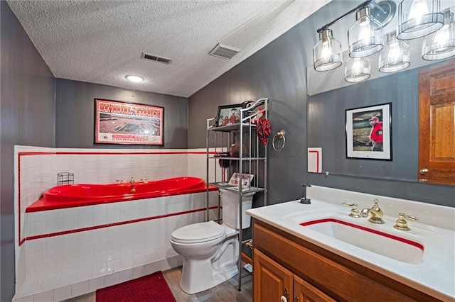 bathroom with visible vents, a textured ceiling, toilet, and vanity