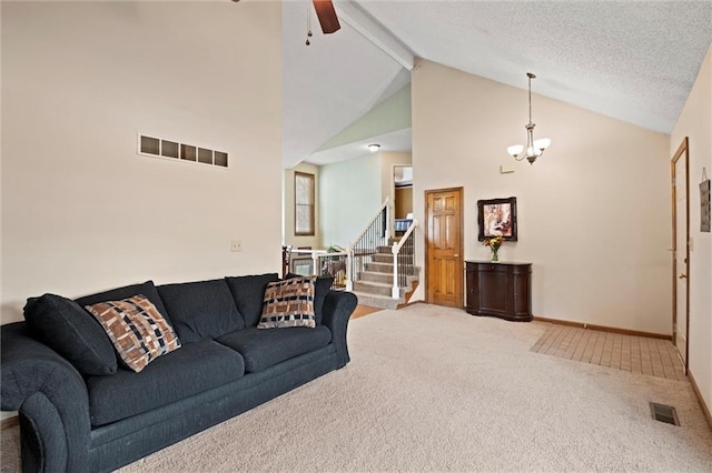 living area with stairs, beamed ceiling, carpet flooring, and visible vents