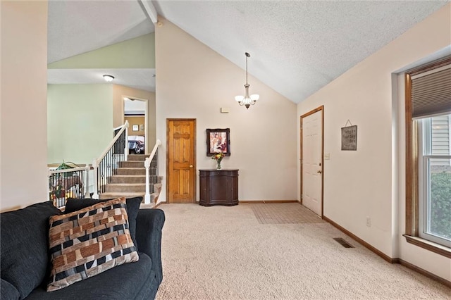 interior space with visible vents, light colored carpet, stairway, a textured ceiling, and baseboards