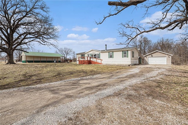 manufactured / mobile home featuring an outbuilding and a detached garage